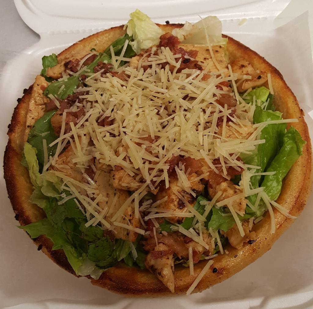 Chicken Caesar  · Freshly baked bread bowl filled with crisp salad greens topped with seasoned grilled chicken and Parmesan cheese