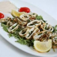 Grilled Calamari · Tender grilled calamari sauteed with tarragon, garlic and butter sauce. Served with our spec...