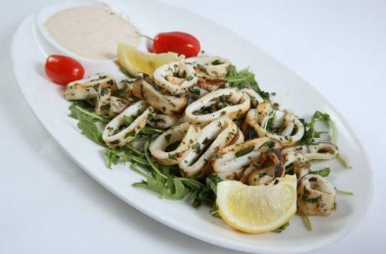 Grilled Calamari · Tender grilled calamari sauteed with tarragon, garlic and butter sauce. Served with our special sauce.