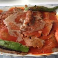 Iskender Kebab (Today Special your get any soda free).  · Doner kebab made beef and lamb Gyro over service bread and topped with fresh tomato sauce an...
