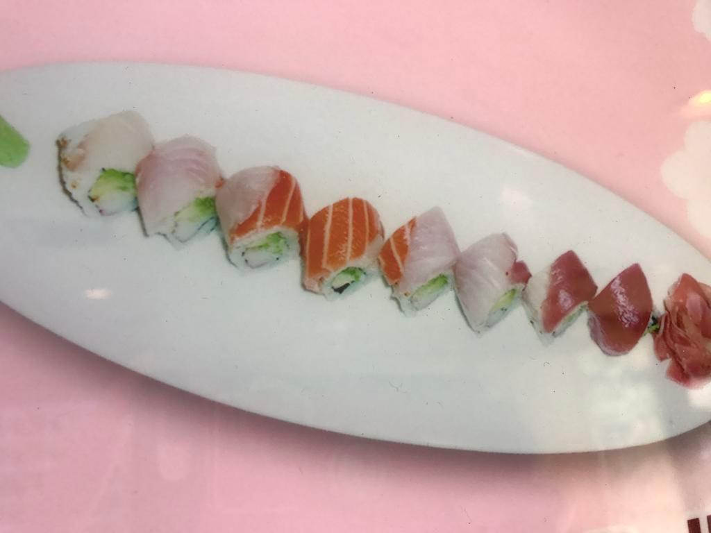 Rainbow Roll · Crab, cucumber, and avocado inside, variety of fish outside.