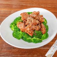 SESAME CHICKEN · Breaded and fried boneless chicken pieces coated with sweet sauce and topped with sesame see...