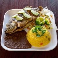 Pescado Frito · Fried fish with fried banana slices and cabbage salad.