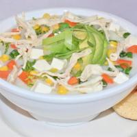 Chicken Soup · Creamy chicken soup with potatoes, carrots, corn, avocado, and fresh white cheese served wit...