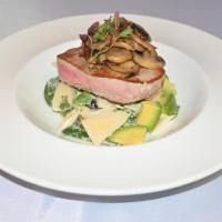 Coast Tuna · Yellow fish tuna over hearts of palm, avocado and cilantro salad topped with sauted garlic m...