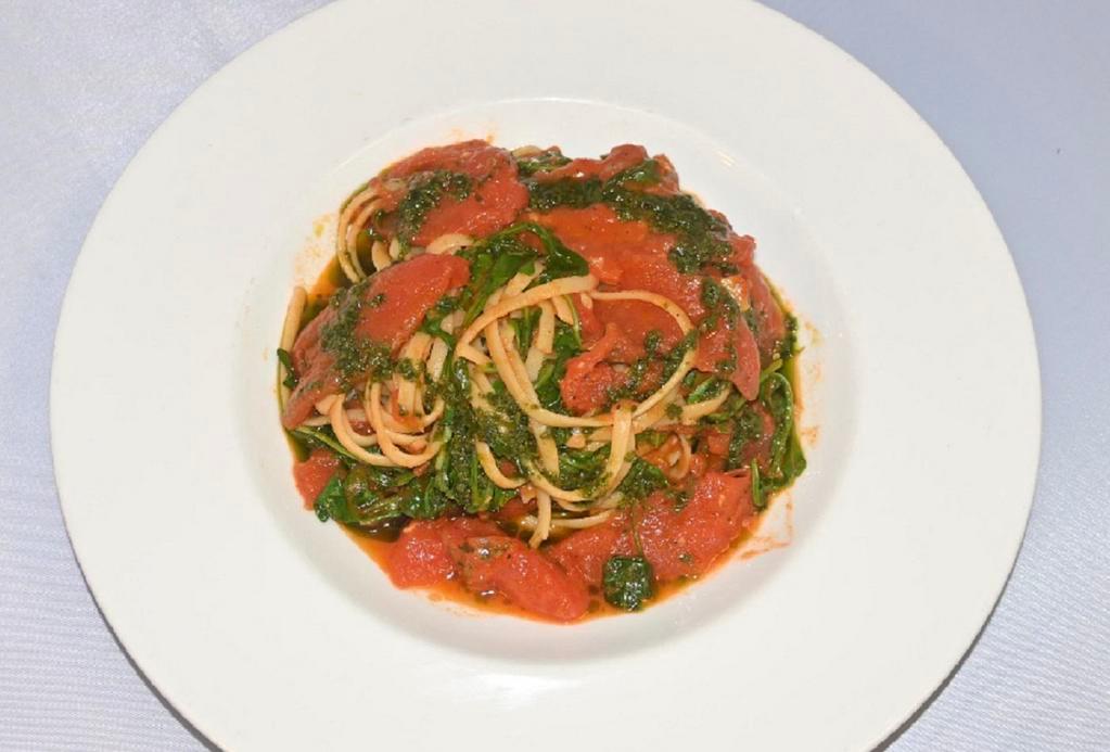 Linguini al Pomodoro · Linguini al Pomodoro with arugula, topped with Basil Pesto sauce.