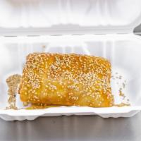 Greek Empanada · Feta cheese wrapped in phyllo (filo) with sesame seeds and honey drizzle