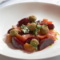 Bietole · Roasted beets with pistachio goat cheese and orange confit.