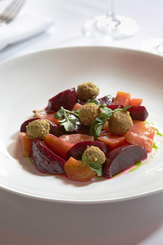 Bietole · Roasted beets with pistachio goat cheese and orange confit.