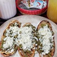 3 Tlacoyos · Handmade tortilla filled with beans, topped with cactus, onion and cheese.