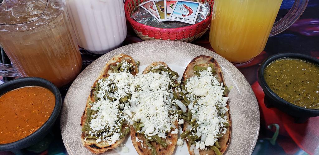 3 Tlacoyos · Handmade tortilla filled with beans, topped with cactus, onion and cheese.