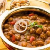 Chana Masala Platter · Chickpeas cooked in a tomato sauce with onions and spices. Served with basmati rice, raita a...