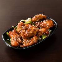 Chicken Poppers · Tender pieces of chicken tossed in our signature sauce.