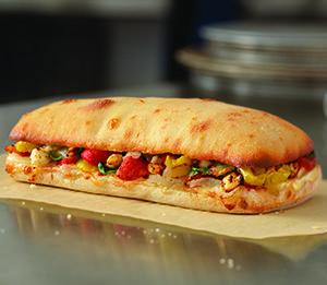 Mediterranean Veggie Sandwich  · Roasted red peppers, banana peppers, diced tomatoes, fresh baby spinach, fresh onions and feta, provolone and American cheeses. Served on our artisan bread. Vegetarian.