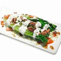 Wedge Salad · Romaine heart topped with tomatoes, red onions, bacon bits and gorgonzola crumbles. Served w...