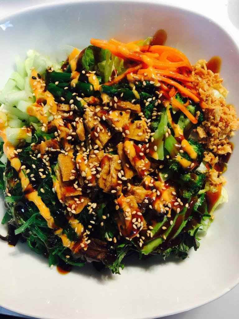 Vegetable Poke Bowl · Fresh Veggies comes with Inari, seaweed salad, avocado, asparagus, cucumber, broccoli, onion crunch, carrot, with sweet & spicy sauce. 