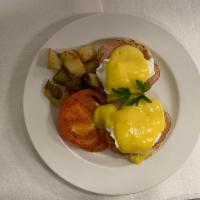 Eggs Benedict · Poached eggs served on toasted muffin, potatoes, roasted tomatoes and Canadian bacon.