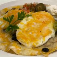 Huevos Rancheros · Corn tortilla topped with black beans, chorizo, fried eggs, cheese, pico de gallo and sour c...