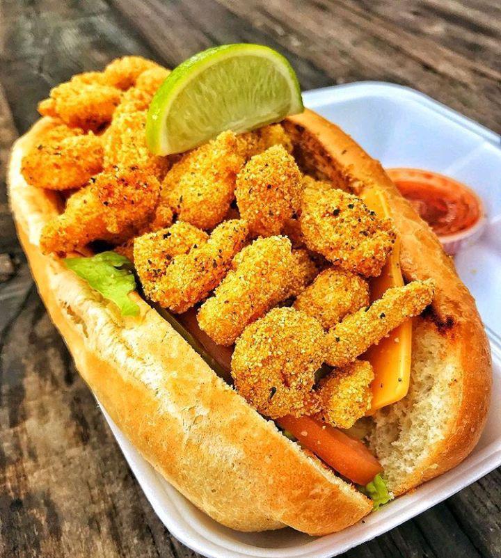 Shrimp Po Boy · Fried shrimp, lettuce, tomatoes, pickles, onions, cheese, served on a soft roll, with choice of signature sauce.