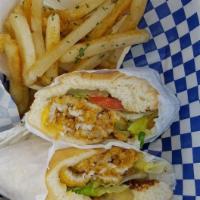 Catfish Po Boy · Fried catfish fillet, lettuce, tomatoes, pickles, onions, cheese, served on a soft roll, wit...
