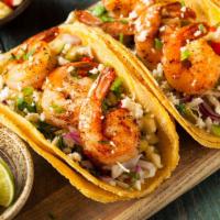 Shrimp Taco · 9 large shrimp laid in 3 soft tortillas with, lettuce, corn salsa, slaw,  and drizzled with ...