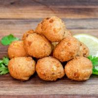Hush Puppies · Delightfully deep-fried and perfectly seasoned, with whole kernels of corn in the batter. A ...