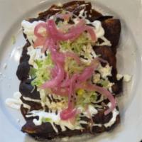 Enchilada · Tortilla stuffed with chicken barbacoa, with our top of homemade mole, sour cream, queso fre...