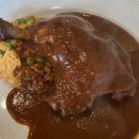 Homemade Chicken Mole · Served with 1/2 chicken. Mole made with 7 different kinds of pepper served with a side of ri...