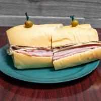 Cuban Sandwich  · Serrano ham, Swiss cheese, Roasted pork, and Pickles on Cuban bread.