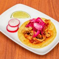 Taco de Tinga · Chicken stew with tomato, onions and chipotle peppers. Topped with red pickled onions. 