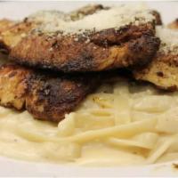 Cajun Fettucini Alfredo · Delicate fettucini in a creamy parmigiano sauce with blackened chicken. Served with a side o...