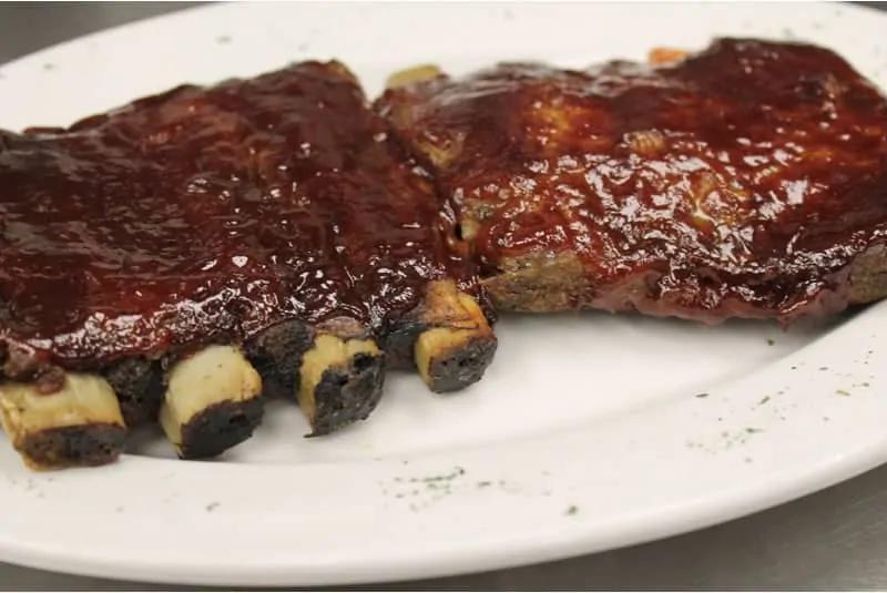 BBQ Ribs · Meaty St. Louis ribs basted with sweet baby ray’s sauce. Served with 2 sides of your choice.