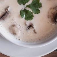 Tom Kha Gai · Chicken soup with coconut milk, lemongrass, galangal, lime juice, mushrooms, and scallions.