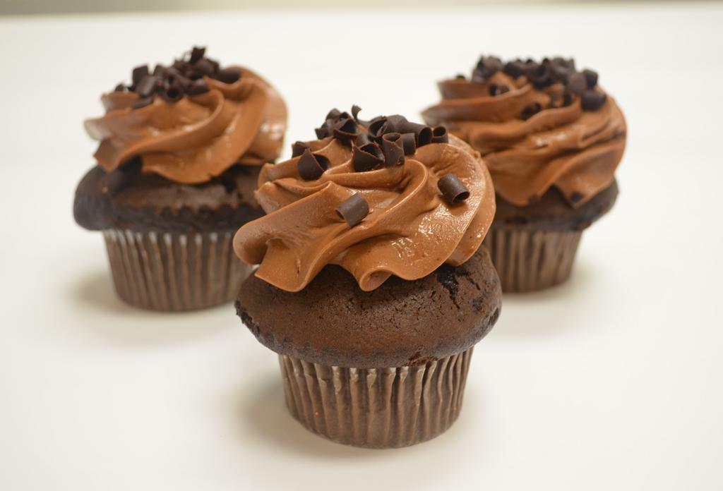 Chocolate Fix · Moist chocolate cake drenched in delicious chocolate butter cream frosting topped with chocolate shavings. 