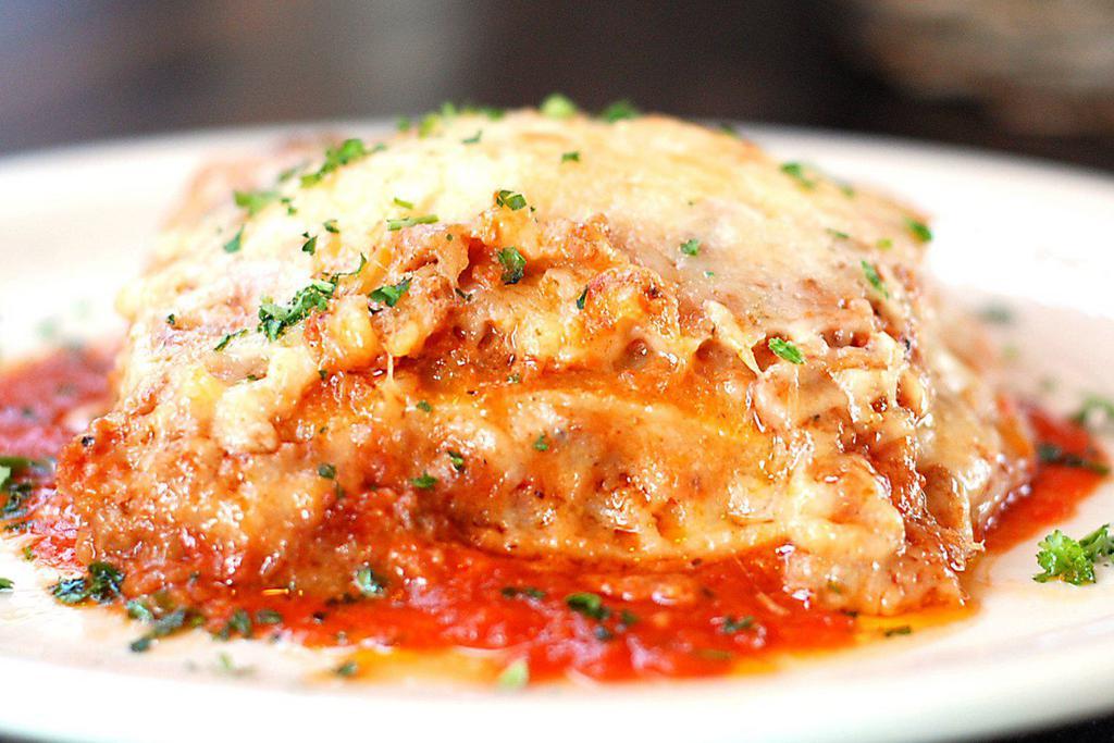 Lasagna di FIGO* · Thin sheets of fresh egg pasta with meat ragu, bechamel sauce, mozzarella, and Parmigiano Reggiano.
