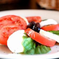Caprese Salad* · Fresh buffalo mozzarella with vine-ripened tomatoes, basil, Kalamata olives and Tuscan extra...