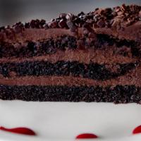 Chocolate Cake* · Moist chocolate cake filled with dark chocolate frosting and chocolate flakes.