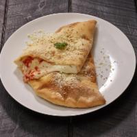 Calzone · folded pizza filled with ricotta, mozzarella, parmesan, herbs and spices