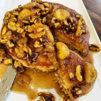 Banana Nut Pancakes · 3 buttermilk pancakes topped with walnut and pecan butter sauce.