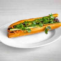 GRILLED BEEF BANH MI · GRILLED BEEF STUFFED IN A FRENCH BAGUETTE SERVED WITH VIETNAMESE HERBS AND PICKLED VEGGIES (...
