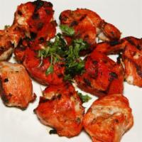 Chicken Boti Tandoori · Marinated chicken breast pieces cooked in a charcoal barbeque.
