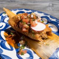 Tamale - Chicken · Chicken tamale in red salsa.
Topped with a three red pepper sauce.