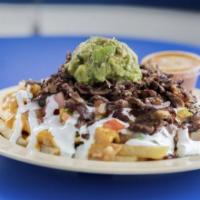 Super Fries · French fries topped with refried beans, nacho cheese, fresh guacamole, sour cream, and pico ...