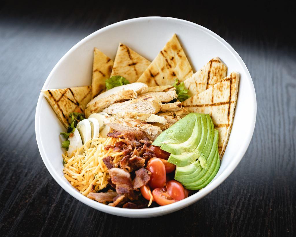 Chicken Cobb Salad · Grilled chicken breast with lettuce, sliced tomatoes and avocado, onions, bacon bits, and a hardboiled egg. Served with pita bread.