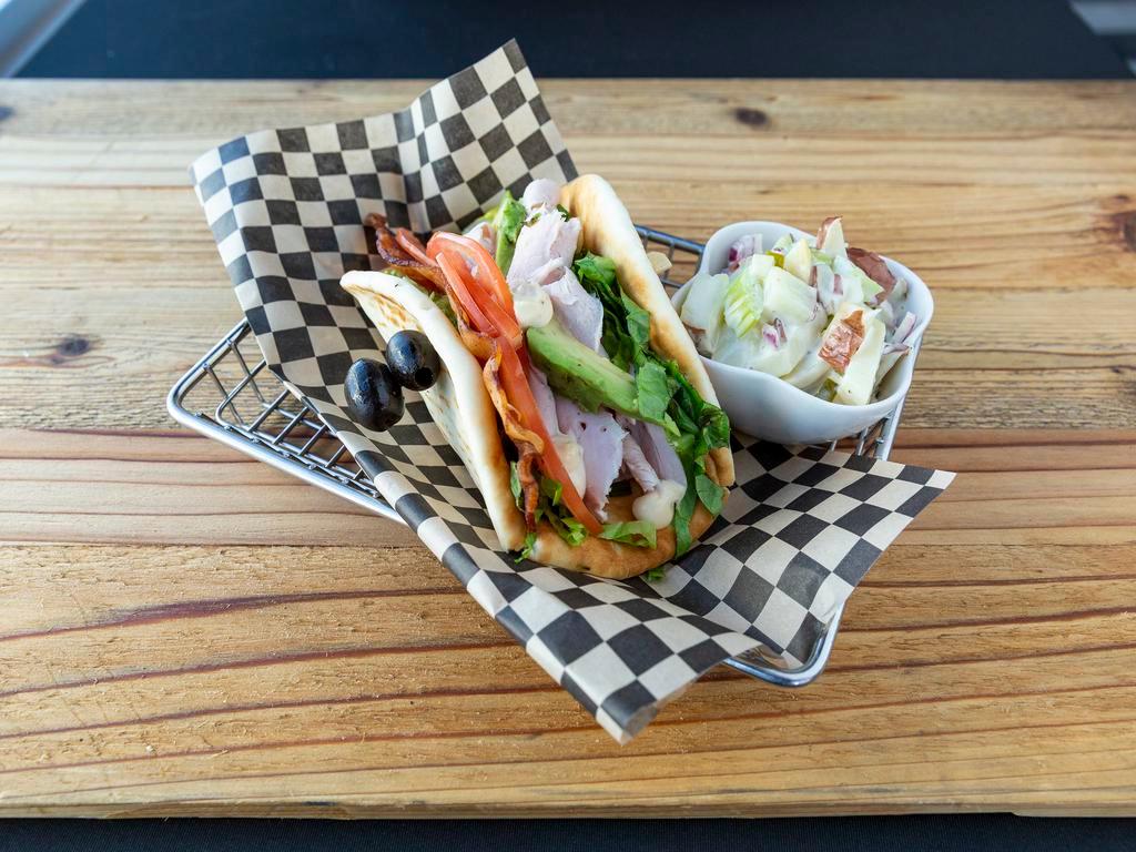 Penthouse Pita Sandwich · Daily's bacon, roasted turkey, lettuce, tomatoes, avocado, melted provolone, and house aioli served on pita bread.