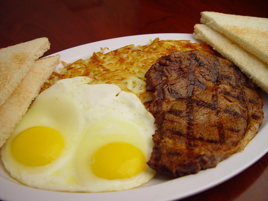 2. Steak and Eggs · Juicy beef steak and two eggs. Served with hash brown, toast and jelly. 