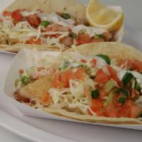 Grilled Fish Tacos · Individual fish taco with fish fillet, cabbage, pico de gallo, cream and lemon.