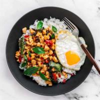 Thai Chicken Basil · Chicken, diced red pepper, fresh basil with a fried egg, black pepper sprinkled on top and a...