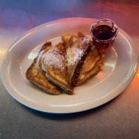 French Toast · 4 wedges of French toast grilled and topped with powdered sugar.