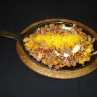 Meat Lover’s Skillet · 2 eggs on country potatoes, topped with bacon, ham, sausage and shredded cheddar cheese.